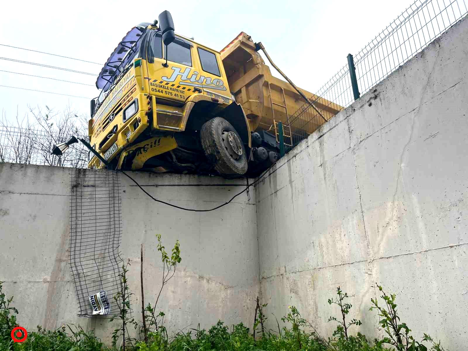 Hafriyat kamyonu istinat duvarında askıda kaldı